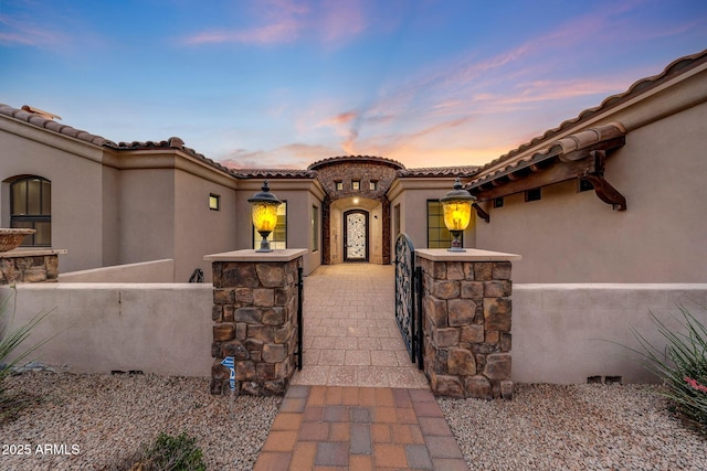 26204 S Washington St, Chandler, AZ 85249 - exterior entry at dusk with stucco siding and a tiled roof