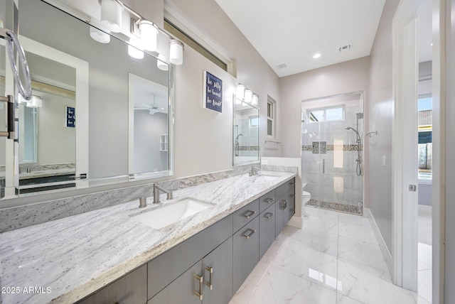 26204 S Washington St, Chandler, AZ 85249 - bathroom featuring a shower stall, double vanity, marble look tiles, a ceiling fan, and recessed lighting