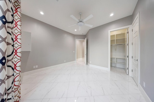 26204 S Washington St, Chandler, AZ 85249 - unfurnished bedroom featuring recessed lighting, marble finish floors, a spacious closet, and a ceiling fan