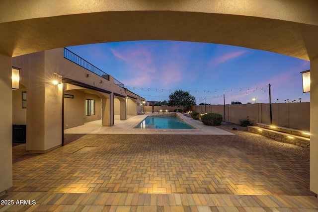 26204 S Washington St, Chandler, AZ 85249 - pool at dusk with a patio and a fenced backyard