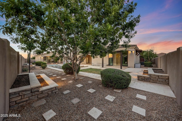 26204 S Washington St, Chandler, AZ 85249 - yard at dusk with a patio area and a fenced backyard