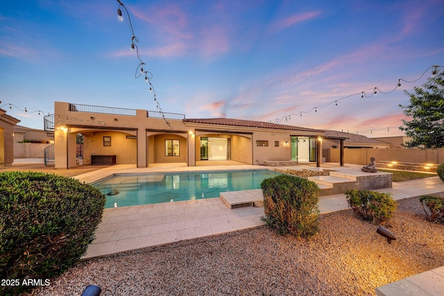 26204 S Washington St, Chandler, AZ 85249 - back of property at dusk with a patio area, stucco siding, and a tile roof