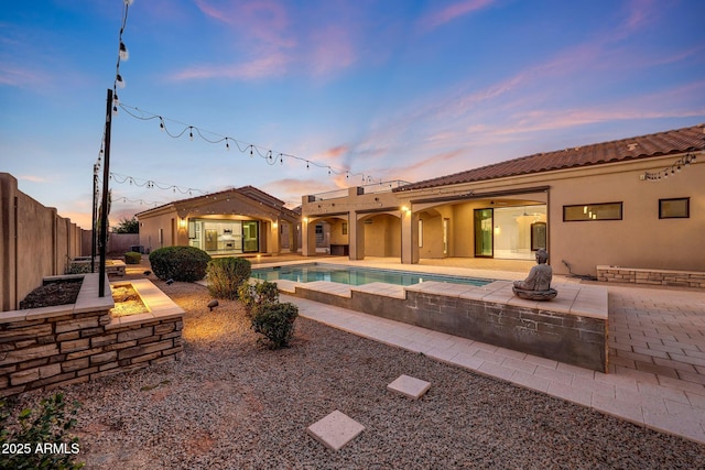 26204 S Washington St, Chandler, AZ 85249 - rear view of property with an outdoor fire pit, a patio area, a fenced backyard, stucco siding, and a tile roof