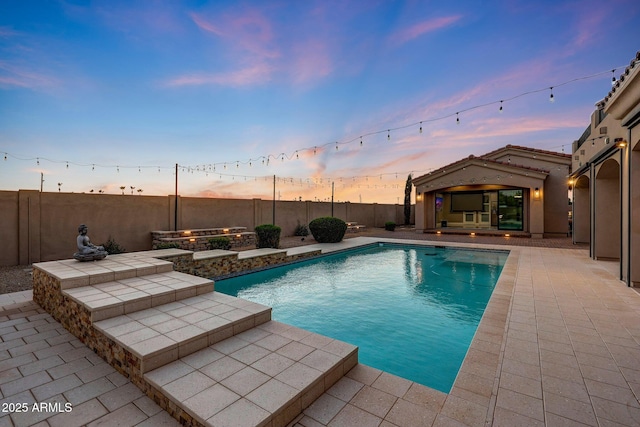 26204 S Washington St, Chandler, AZ 85249 - pool at dusk with a patio area and a fenced backyard