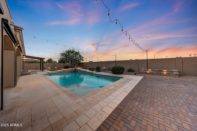 26204 S Washington St, Chandler, AZ 85249 - pool at dusk featuring a patio and a fenced backyard