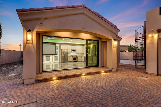 26204 S Washington St, Chandler, AZ 85249 - back of house at dusk featuring stucco siding, stairs, and a tiled roof
