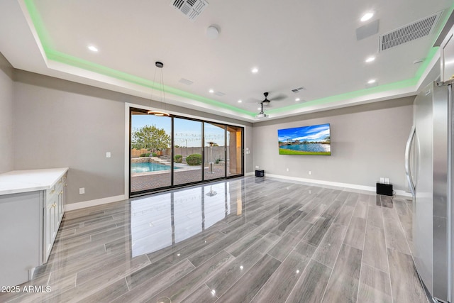 26204 S Washington St, Chandler, AZ 85249 - unfurnished living room featuring a raised ceiling, light wood-type flooring, and recessed lighting