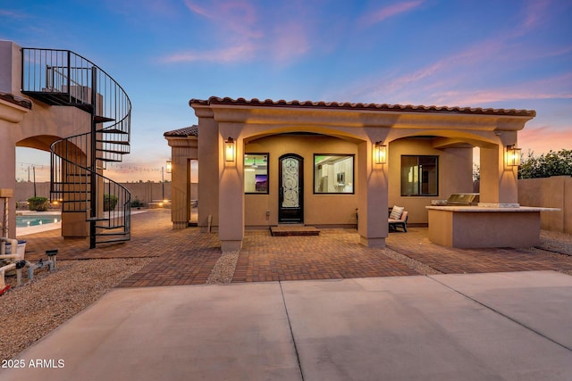 26204 S Washington St, Chandler, AZ 85249 - back of house featuring stairway, a patio area, an outdoor kitchen, a tiled roof, and stucco siding
