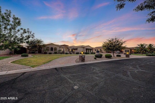 26204 S Washington St, Chandler, AZ 85249 - mediterranean / spanish house featuring a lawn, a residential view, and curved driveway