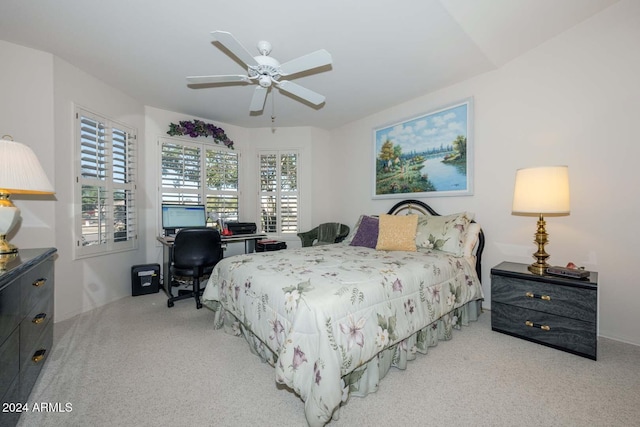 carpeted bedroom featuring ceiling fan and multiple windows