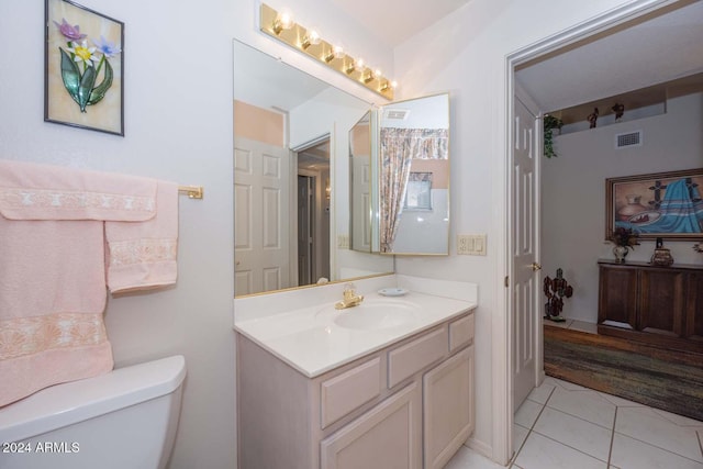 bathroom with tile patterned floors, vanity, and toilet