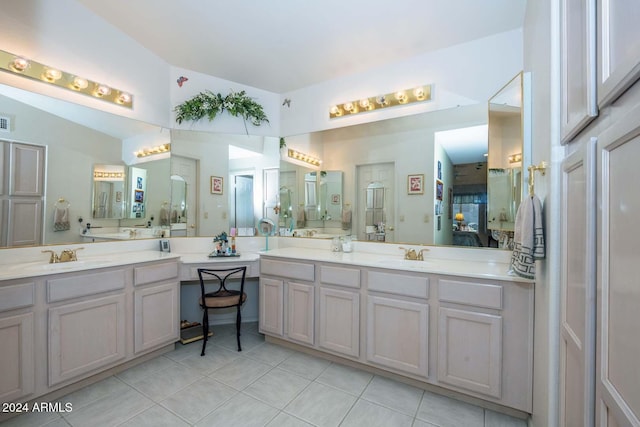 bathroom featuring vanity, tile patterned floors, and lofted ceiling