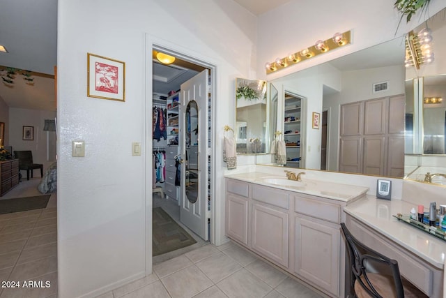 bathroom featuring tile patterned floors, vanity, and lofted ceiling