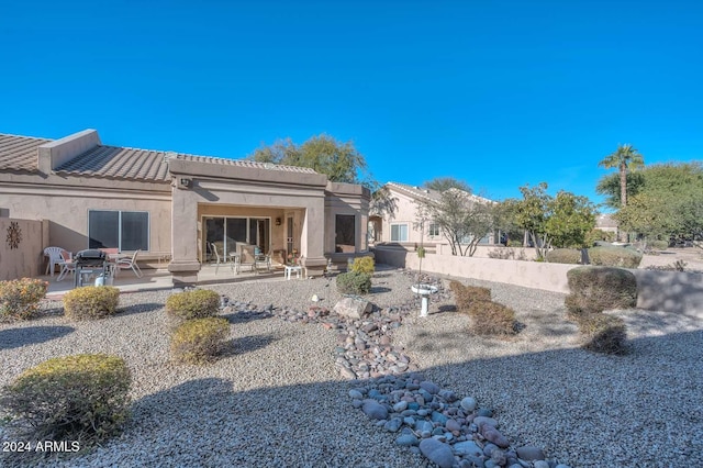 rear view of property featuring a patio area