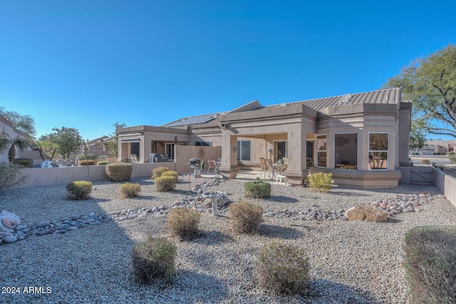 back of property featuring a patio area