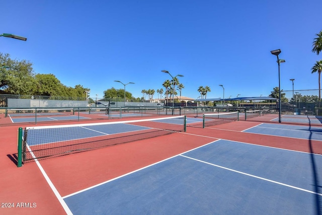 view of tennis court with basketball hoop