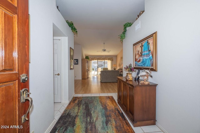 hall featuring light tile patterned floors