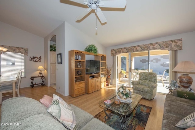 living room with ceiling fan, light hardwood / wood-style floors, and lofted ceiling