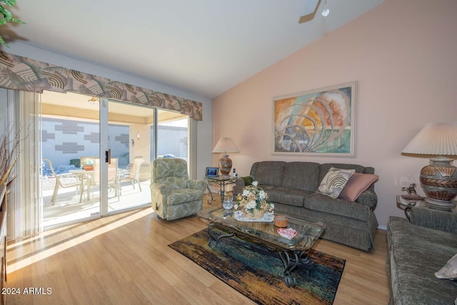 living room featuring light wood-type flooring, vaulted ceiling, and ceiling fan