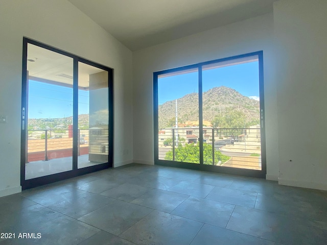 spare room with a mountain view