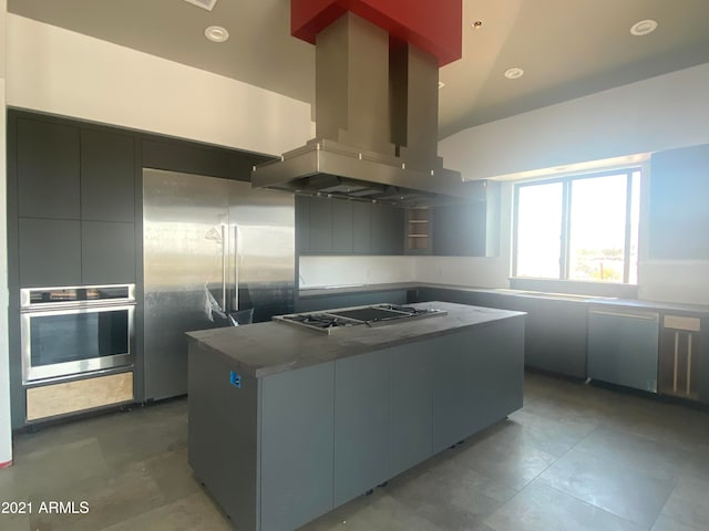 kitchen featuring lofted ceiling, a kitchen island, stainless steel appliances, and island exhaust hood