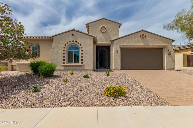 26860 N 102nd Ln, Peoria, AZ 85383 - mediterranean / spanish-style home featuring a garage, driveway, a tile roof, and stucco siding
