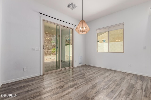 26860 N 102nd Ln, Peoria, AZ 85383 - empty room with visible vents, baseboards, and wood finished floors
