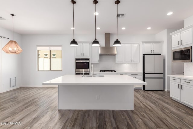 26860 N 102nd Ln, Peoria, AZ 85383 - kitchen with wall chimney range hood, visible vents, built in microwave, a sink, and freestanding refrigerator