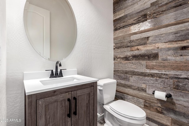 26860 N 102nd Ln, Peoria, AZ 85383 - bathroom with wooden walls, toilet, a textured wall, and vanity