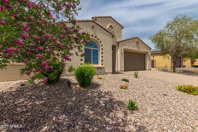 26860 N 102nd Ln, Peoria, AZ 85383 - mediterranean / spanish-style home featuring a garage, stucco siding, driveway, and a tile roof