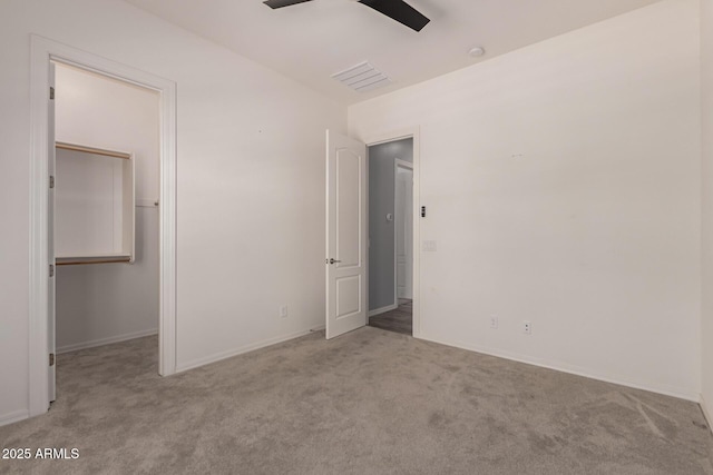 26860 N 102nd Ln, Peoria, AZ 85383 - unfurnished bedroom with a walk in closet, baseboards, carpet flooring, and visible vents