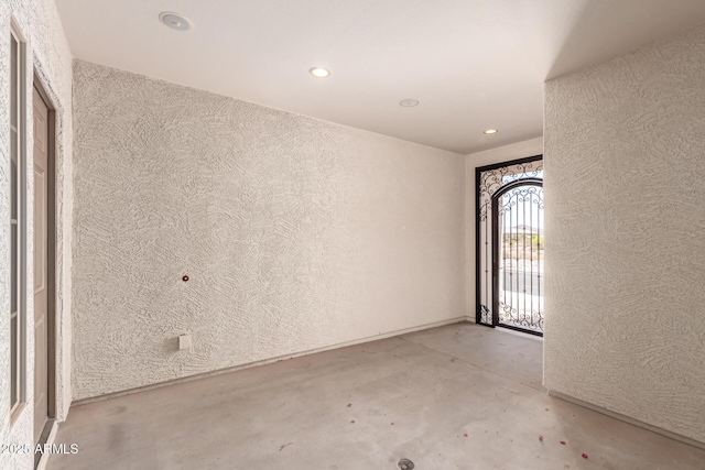 26860 N 102nd Ln, Peoria, AZ 85383 - unfurnished room featuring recessed lighting, a textured wall, and unfinished concrete flooring