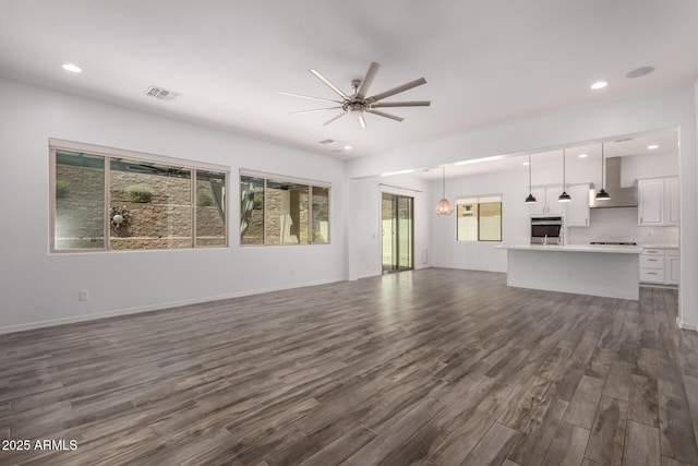 26860 N 102nd Ln, Peoria, AZ 85383 - unfurnished living room featuring visible vents, a ceiling fan, dark wood-type flooring, and recessed lighting