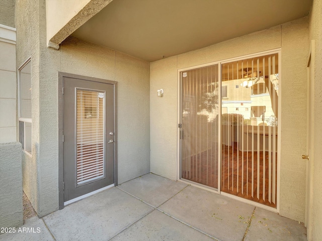 doorway to property with stucco siding