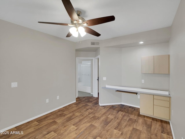 kitchen with visible vents, wood finished floors, light countertops, baseboards, and ceiling fan