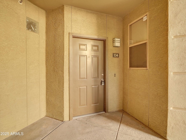 entrance to property featuring stucco siding