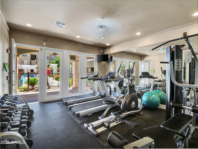 exercise room with visible vents, recessed lighting, and a textured ceiling