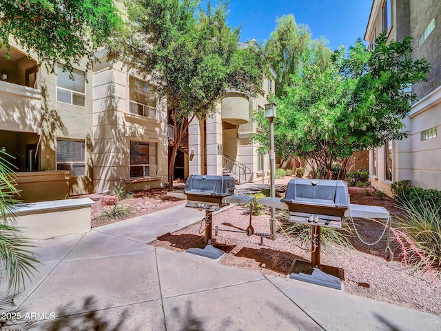 view of home's community with fence and a patio area