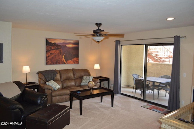 living area with a ceiling fan, recessed lighting, and light colored carpet