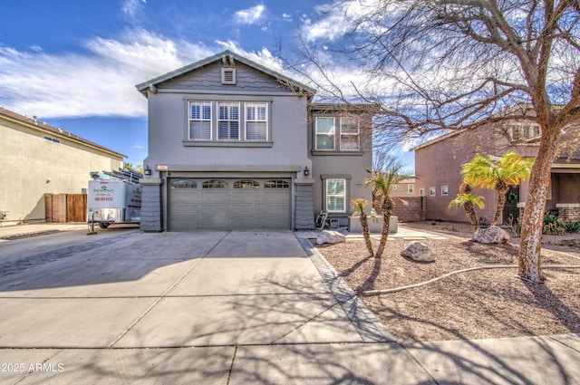 traditional home featuring a garage, driveway, and stucco siding