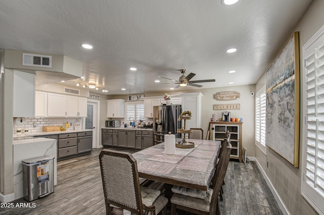 dining space featuring baseboards, visible vents, dark wood-style flooring, and recessed lighting