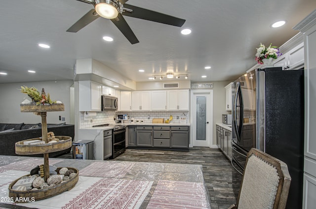 kitchen with stainless steel appliances, gray cabinets, light countertops, visible vents, and backsplash