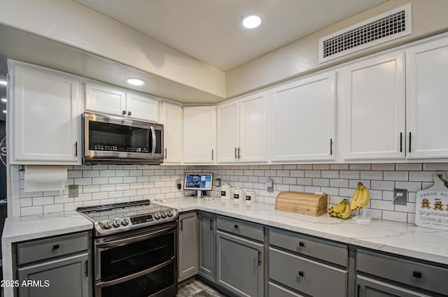 kitchen featuring gray cabinets, visible vents, and stainless steel appliances