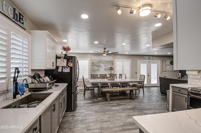 kitchen with french doors, stainless steel electric range, a sink, and a healthy amount of sunlight