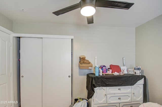 bedroom featuring ceiling fan and a closet