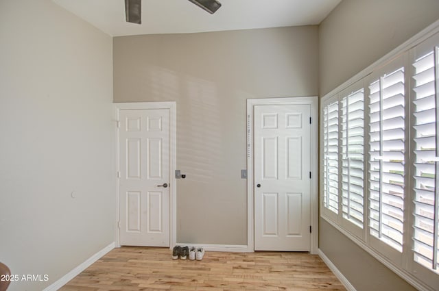 empty room featuring light wood-type flooring and baseboards