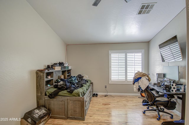 office area with baseboards, visible vents, and light wood finished floors