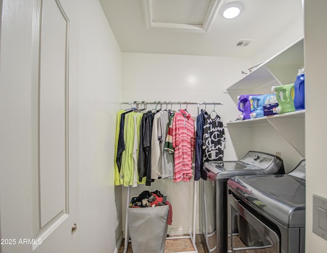 washroom featuring attic access, laundry area, visible vents, and separate washer and dryer