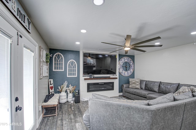 living room with ceiling fan, wood finished floors, a glass covered fireplace, and recessed lighting