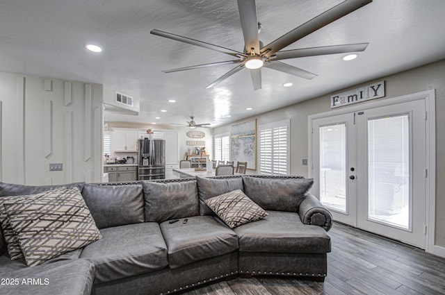 living area featuring ceiling fan, recessed lighting, wood finished floors, visible vents, and french doors